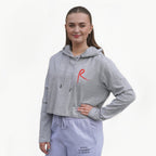 Heather grey cropped hoodie with a red arabesque symbol on the front and the Royal Academy of Dance logo on the cuff.