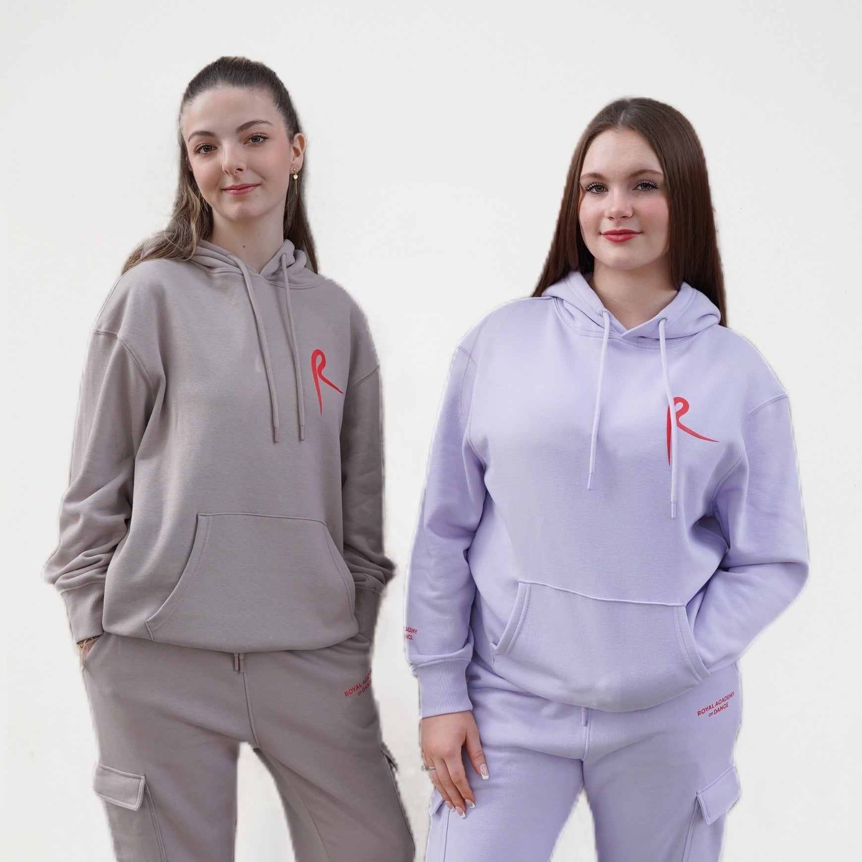 Hoodie with a drawstring and a kangaroo pocket. Arabesque R on chest and Royal Academy of Dance on cuff in red. 