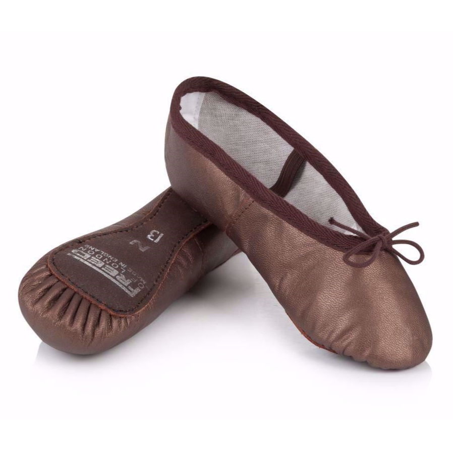 RAD approved brown leather ballet shoes designed for durability and foot strength. These technical slippers feature a full suede sole and pre-sewn elastics, making them a standard requirement for Royal Academy of Dance examination uniforms. The high-quality leather upper provides essential support for all grades. As technical dance footwear fits differently than fashion shoes, refer to the sizing guide and consider ordering one size larger than your street shoe for a professional fit