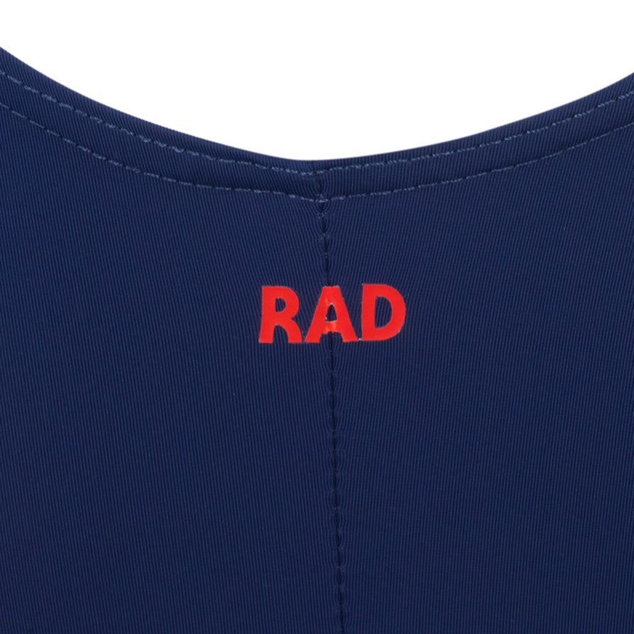 Briony navy leotard is a staple of the 2025 Royal Academy of Dance (RAD) uniform for female dancers in all grades. It features a classic capped sleeve silhouette with a front ruche and an elasticated matching belt to highlight clean ballet lines. This regulation dancewear is crafted from sustainable ECONYL recycled fabric, reflecting the trend for eco-friendly ballet attire. Ideal for exams and daily training, it provides a sophisticated, professional look for aspiring ballerinas