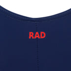 Briony navy leotard is a staple of the 2025 Royal Academy of Dance (RAD) uniform for female dancers in all grades. It features a classic capped sleeve silhouette with a front ruche and an elasticated matching belt to highlight clean ballet lines. This regulation dancewear is crafted from sustainable ECONYL recycled fabric, reflecting the trend for eco-friendly ballet attire. Ideal for exams and daily training, it provides a sophisticated, professional look for aspiring ballerinas