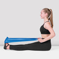 Woman exercising with a resistance band on a white background