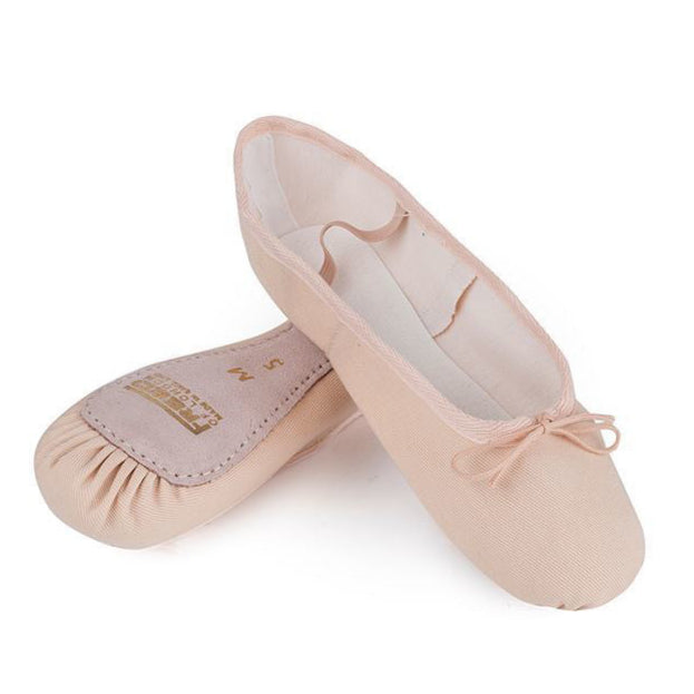 Breathable pink canvas ballet shoes, a lightweight technical slipper approved for RAD uniforms across all grades. These washable dance shoes feature a full suede sole for stability and pre-sewn elastics for convenience. Ideal for warm studios and daily training, the flexible cotton canvas offers a comfortable, sock-like fit. Because these technical slippers run small, consult the sizing guide; many dancers find that ordering one size up from their street shoe size provides the best fit.