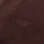 Brown jogger with embroidered " Royal Academy of Dance" logo close up 