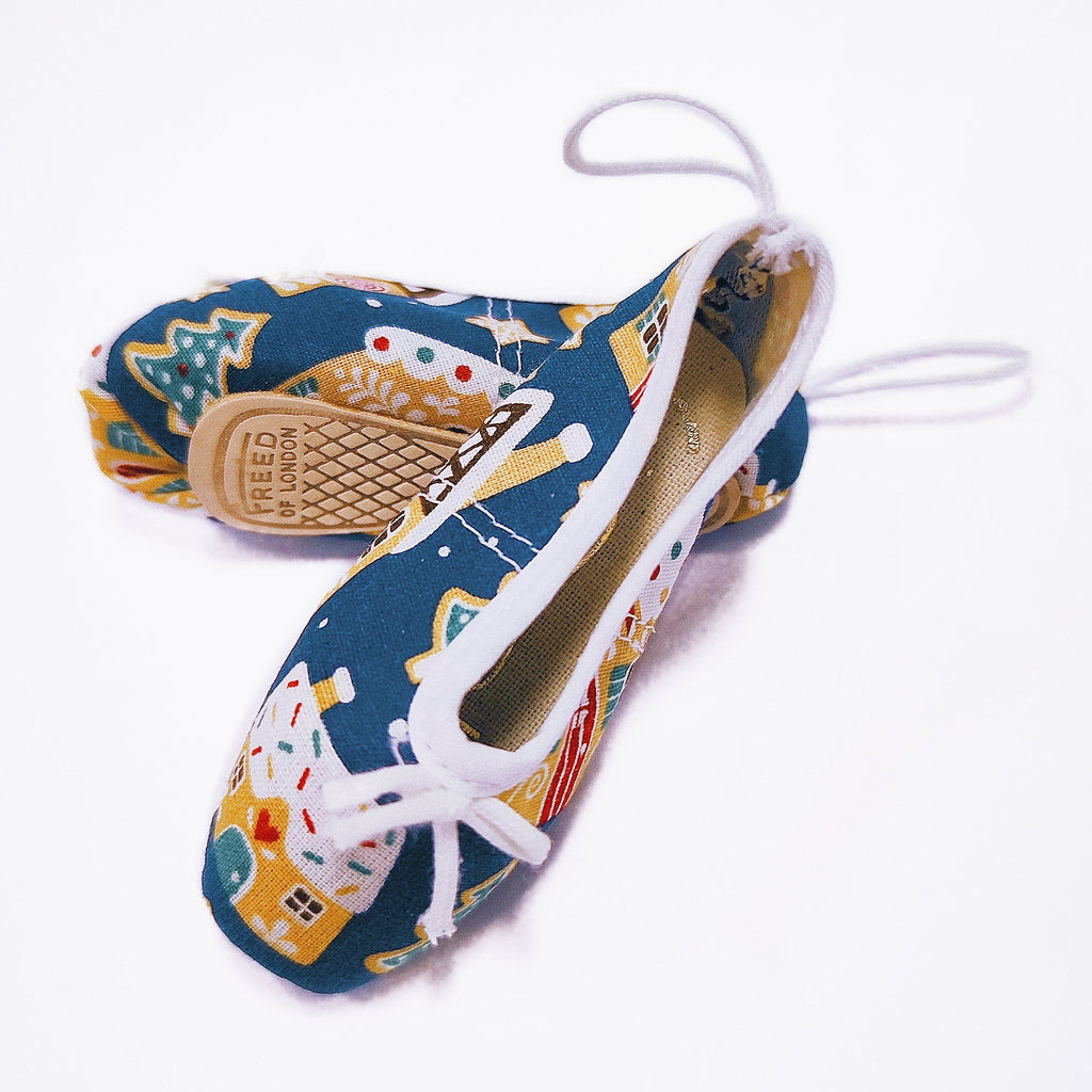 Colorful Christmas shoe ornaments with a pattern on a white background