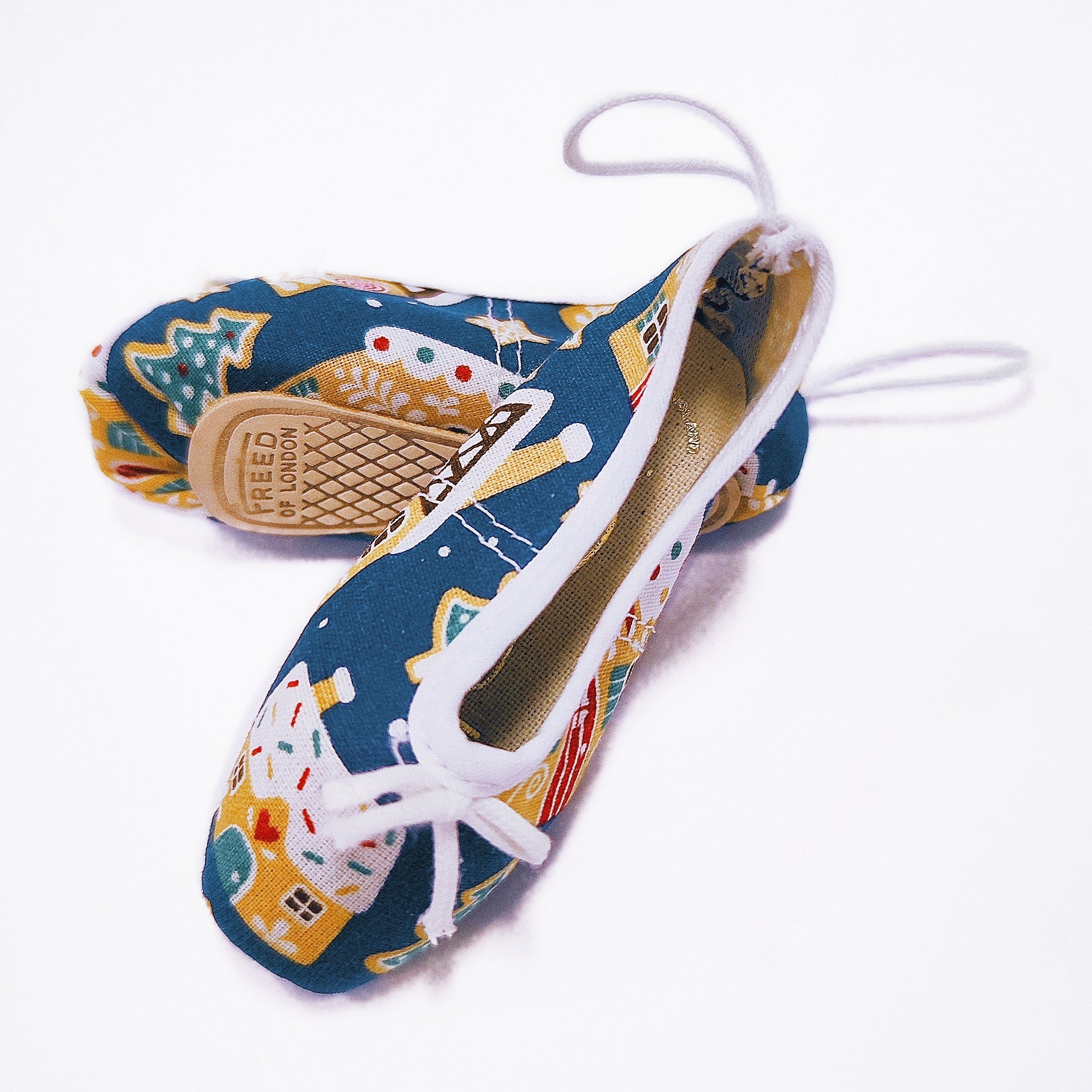 Colorful Christmas shoe ornaments with a pattern on a white background