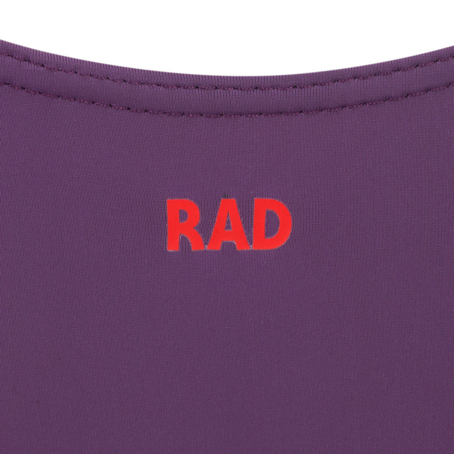 Official RAD Grade 3-5 female ballet uniform: the Freed of London Ivy leotard in Damson. This regulation piece features a sleeveless tank design with a ruched front and matching belt. Made from sustainable ECONYL recycled fabric. Designed for Royal Academy of Dance exams, it combines high-performance recycled materials with a professional, supportive fit for young dancers.