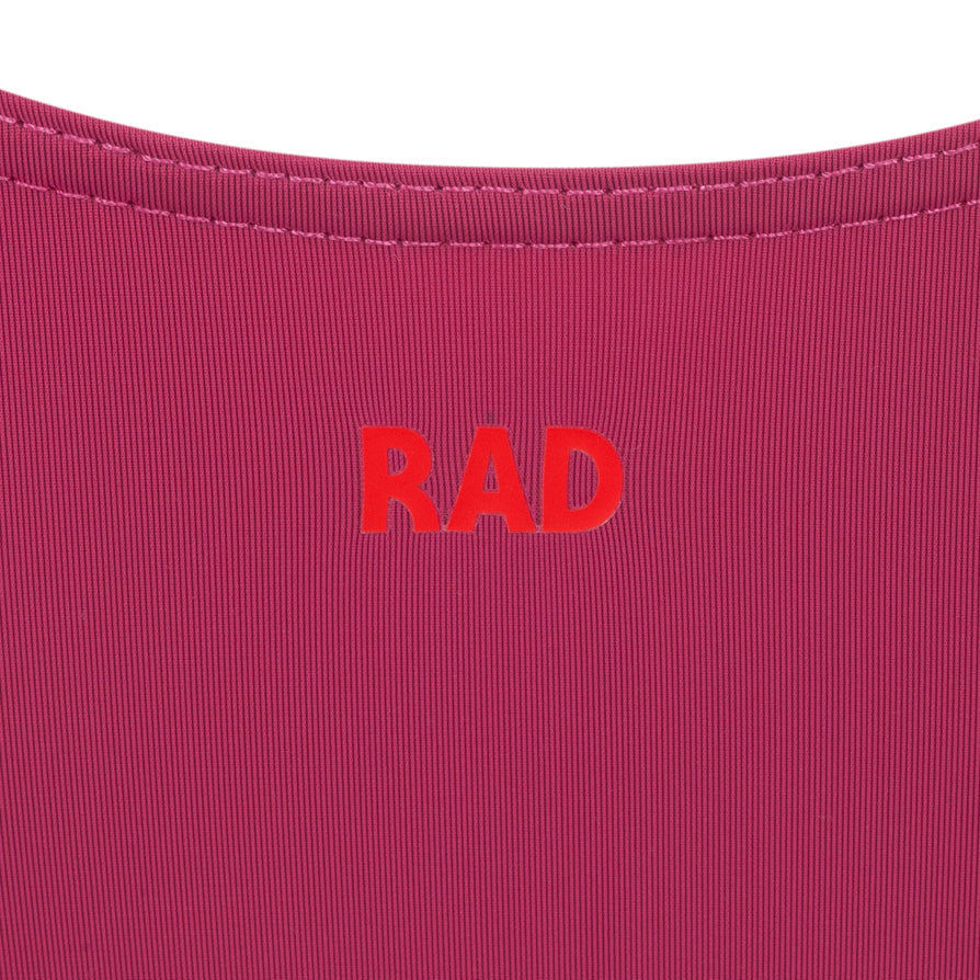 Official RAD Grade 3-5 female ballet uniform: the Freed of London Ivy leotard in Mulberry. This regulation piece features a sleeveless tank design with a ruched front and matching belt. Made from sustainable ECONYL recycled fabric. Designed for Royal Academy of Dance exams, it combines high-performance recycled materials with a professional, supportive fit for young dancers.