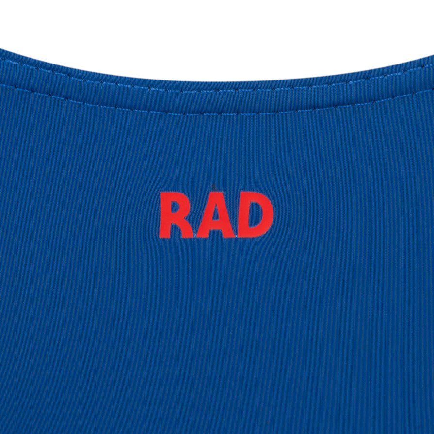 Official RAD Grade 3-5 female ballet uniform: the Freed of London Ivy leotard in royal. This regulation piece features a sleeveless tank design with a ruched front and matching belt. Made from sustainable ECONYL recycled fabric. Designed for Royal Academy of Dance exams, it combines high-performance recycled materials with a professional, supportive fit for young dancers.