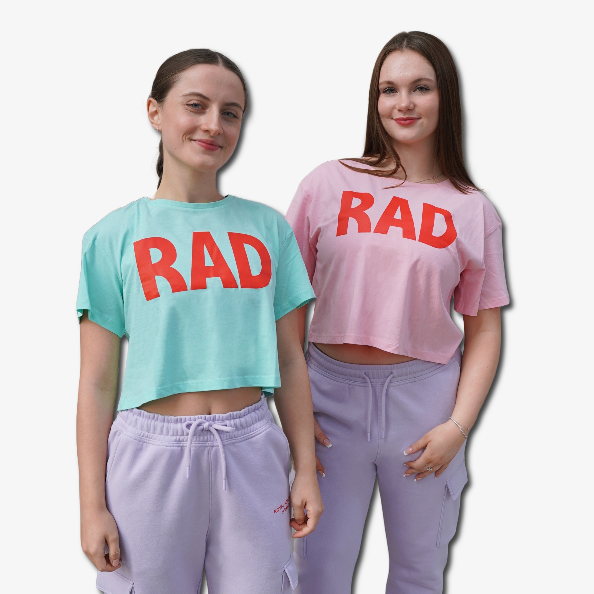 Two people wearing Mint Green and pink cropped t-shirt with 'RAD' logo in red and purple jogger, Royal Academy of Dance