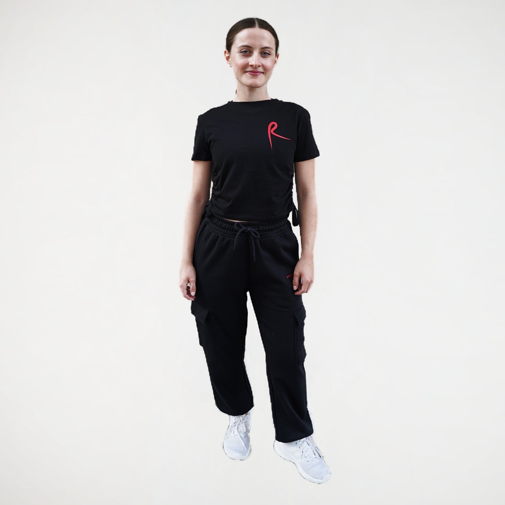 Black fitness jogger with cargo pockets and an elasticated waistband. Royal Academy of Dance logo in red