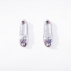 A pair of classic sterling silver stud earrings, each crafted in the shape of a petite, elegant ballet slipper. A single, brilliant cubic zirconia is set at top of the shoe, acting as a sparkling focal point. These dainty studs offer a subtle and refined nod to ballet, perfect for everyday wear. Designed by Royal Academy of Dance. Made in the UK.